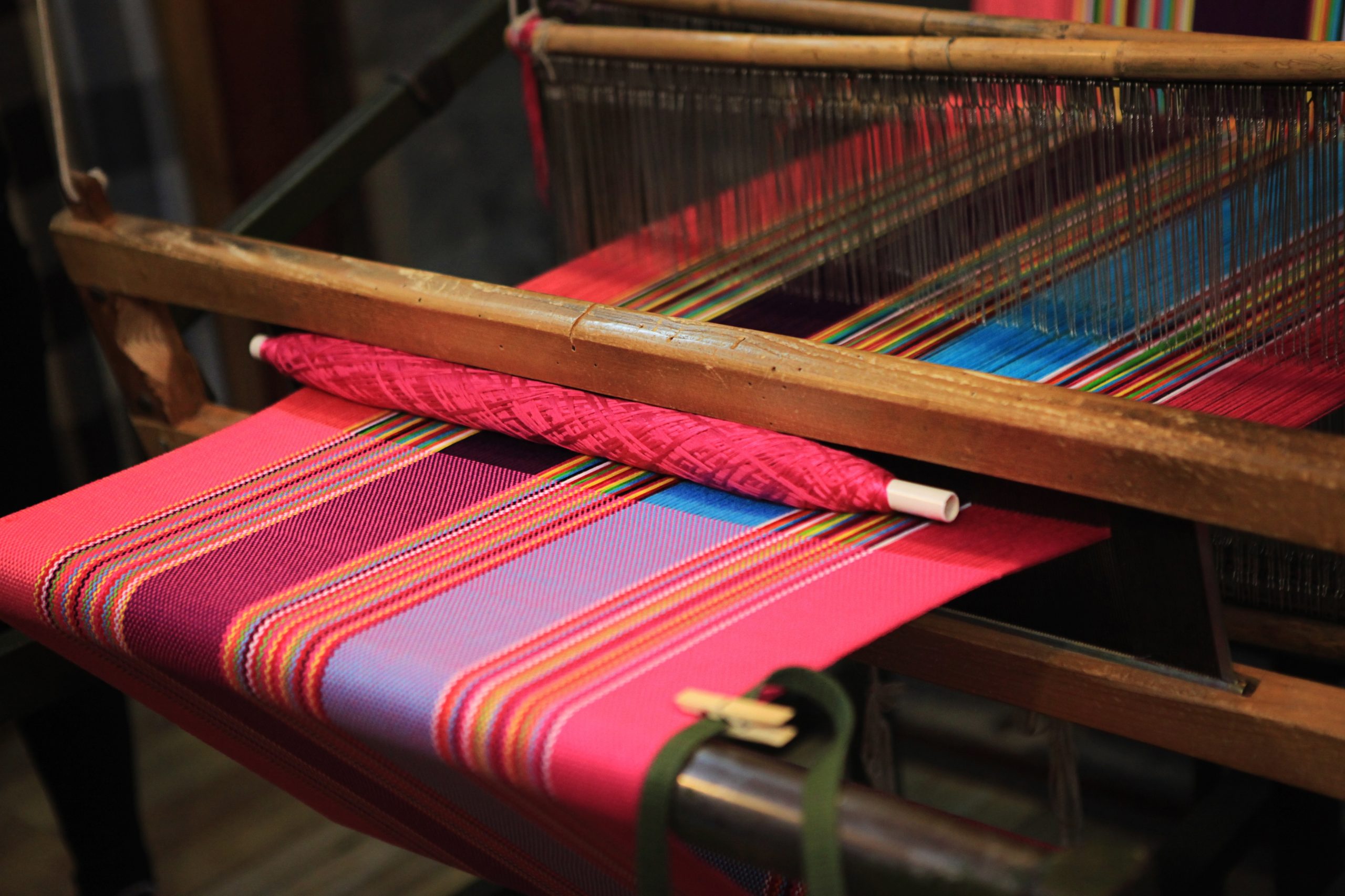 A blanket being made in a loom, like components of a meaningful existence woven together as one blanket